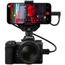 Atomos Ninja Phone Co-Processor connected to Nikon camera recording 10-bit ProRes on iPhone 15 Pro Max with HDR OLED display