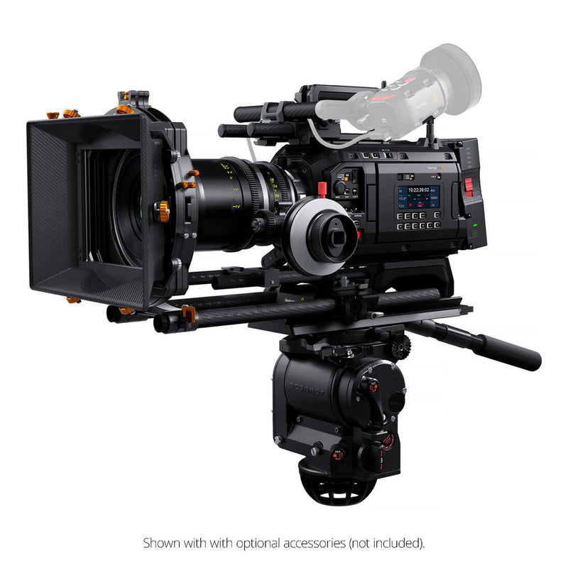 Professional video camera with various attachments on a white background
