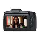 Blackmagic Cinema Camera 6K rear view showing touchscreen with woman smiling in video recording mode