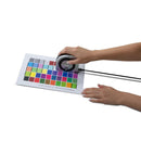 Hands using Calibrite ColorChecker Studio device to profile a color calibration chart