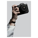 A hand holding the Canon EOS R8 Mark II kit with the EG-E2 Extension Grip Attached
