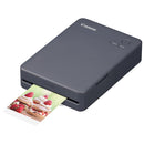 Compact Canon Selphy QX20 wireless photo printer printing a dessert photo with dye-sublimation technology