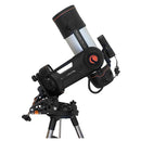 A white and black telescope with orange details, attached to a motorized mount, on a tripod.