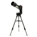 A white and black telescope with orange details, attached to a motorized mount, on a tripod.