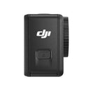 DJI Action 4 compact black action camera side view with lens and logo