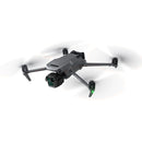 DJI Mavic 3 Pro drone with triple-camera system flying with propellers spinning and green LED light on leg