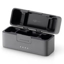 DJI Mic 2 Charging Case open with compartments for two transmitters and one receiver in black compact design