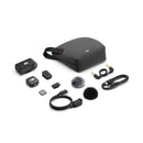 DJI Mic 3 wireless microphone system with compact transmitter, receiver, charging case, cables, and wind muffs laid out on white background