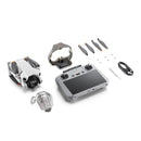 DJI Mini 4 Pro drone with RC 2 controller, propellers, cables, and accessories on white background