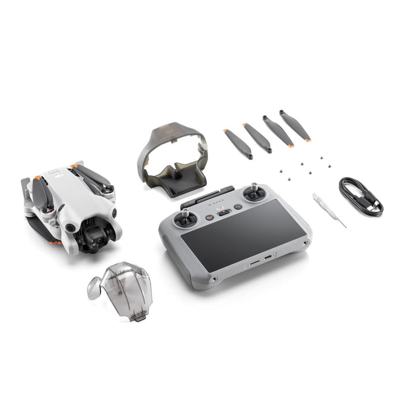 DJI Mini 4 Pro drone with RC 2 controller, propellers, cables, and accessories on white background