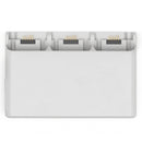 DJI Neo Two-Way Charging Hub white device charging three batteries simultaneously and powering other devices