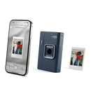Instax camera and smartphone displaying a photo on a white background