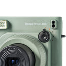 Close-up of green FUJIFILM Instax Wide 400 instant camera with self-timer dial and 95mm lens