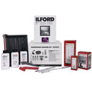 Ilford and Paterson Darkroom Starter Kit with photographic paper, chemicals, trays, cylinders, and darkroom tools for printmaking