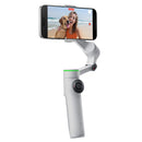 Insta360 Flow 2 Pro smartphone stabilizer with 3-axis gimbal, AI tracking, and built-in selfie stick capturing smooth video of woman with dog