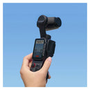 A hand holding the Insta360 Luna Ultra with the sliding protective case in the down position