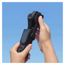 A hand holding the Insta360 Luna Ultra with the sliding protective case in the down position