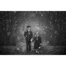 Lensbaby Composer Pro II photo featuring swirly blur and selective focus with two children in vintage attire and gas masks in a tunnel of trees