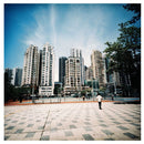 Urban cityscape with tall buildings and open plaza shot on Lomography LomoChrome film with vivid color tones