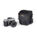 LowePro Adventura TLZ 20 III black compact camera bag with adjustable strap and protective molded base next to silver mirrorless camera