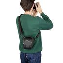 LowePro Adventura TLZ 20 III camera bag worn by person, compact shoulder bag for mirrorless cameras with adjustable strap and protective molded base