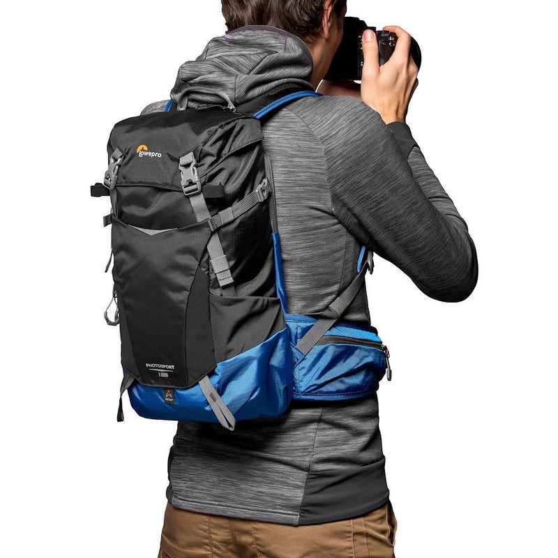 LowePro PhotoSport Outdoor Backpack 15L AW III lightweight weather-resistant camera backpack with padded harness and All Weather AW Cover in use by photographer