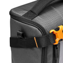 Close-up of LowePro GearUp Creator Box L II camera bag organizer corner with black fabric and orange buckle strap