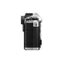 Side view of OM System OM-3 mirrorless camera body showing control dials and textured grip
