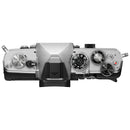 Top view of OM System OM-3 mirrorless camera body showing control dials and buttons in silver finish