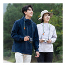 Two people walking outdoors with cameras, surrounded by greenery.