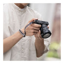 Person holding a camera with a blurred background