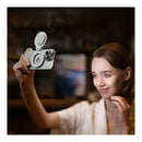 A woman takes a selfie using her phone with the PGYTECH MagGlow fill light attached