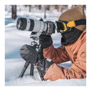 Photographer wearing PGYTech Master Photography Gloves using camera in snowy outdoor setting