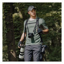 Man wearing PGYTECH Camera Strap Master dual-shoulder camera strap carrying three cameras with lenses outdoors