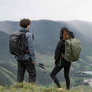 Hikers wearing PGYTECH Focux 35L Backpack with camera gear in mountainous outdoor setting