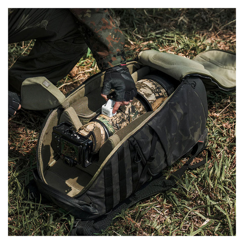 PGYTECH OnePro ST Backpack with customizable padded dividers and camouflage rain cover holding camera gear outdoors
