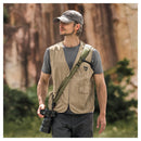 Man wearing PGYTECH Camera Strap Pro with camera outdoors in casual outfit