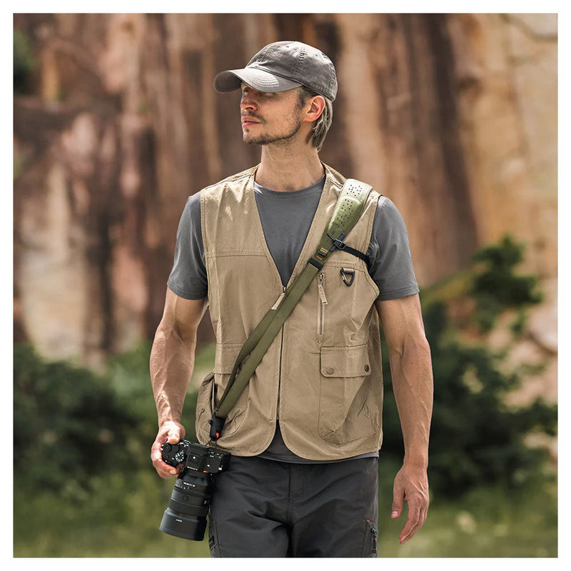 Man wearing PGYTECH Camera Strap Pro with camera outdoors in casual outfit