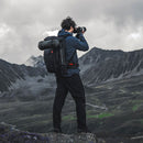 Photographer hiking with PGYTECH OnePro Flex 30L backpack in mountain landscape