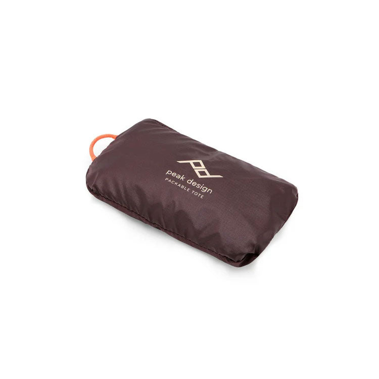 Peak Design Packable Tote folded into compact pouch with durable nylon fabric and logo visible