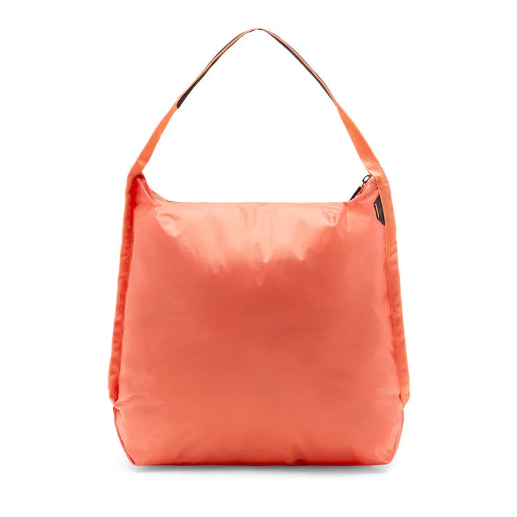 Peak Design Packable Tote in coral orange, ultralight and zippable bag with padded shoulder strap and durable nylon shell