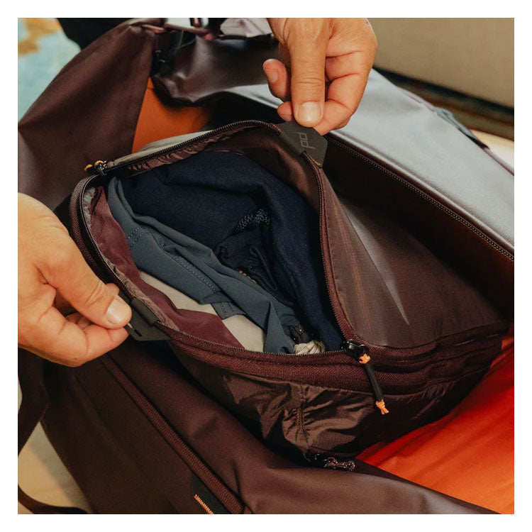 Peak Design Packing Cube Medium with tear-away zipper and expandable compartments inside suitcase