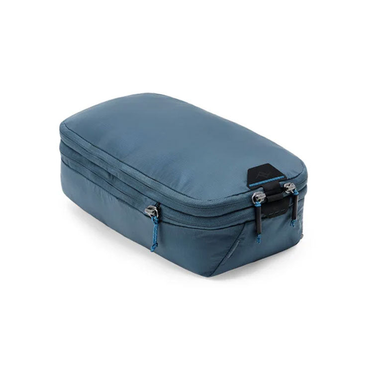 Compact blue Peak Design Packing Cube with tear-away zipper and expandable compartments for organized travel packing