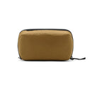 Peak Design Wash Pouch in coyote brown made from recycled fishing nets with a sleek, functional toiletry bag design