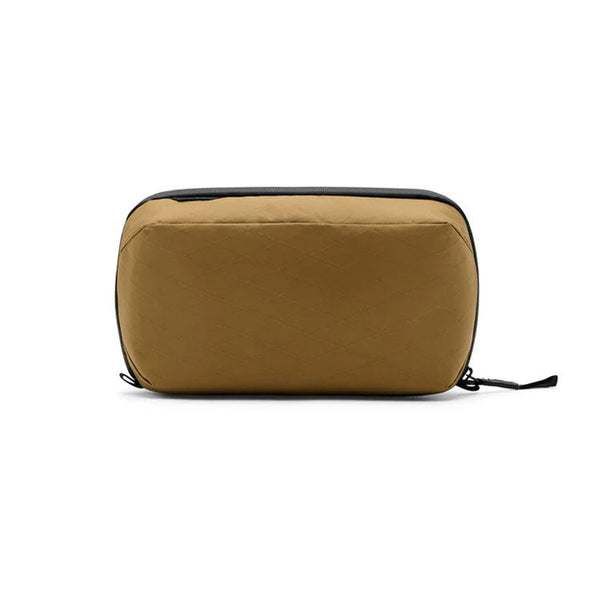 Peak Design Wash Pouch in coyote brown made from recycled fishing nets with a sleek, functional toiletry bag design
