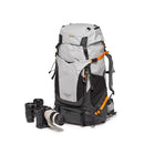 LowePro PhotoSport Backpack PRO 55L AW III in gray with camera gear, designed for professional photographers and outdoor multi-day hiking with waterproof cover and adjustable harness system