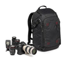 Black camera backpack with camera equipment on a white background