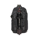 Black backpack with tripod attached to the front.