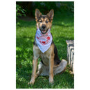 German Shepherd dog wearing The Camera Store limited edition white cotton bandana with red logo outdoors on grass