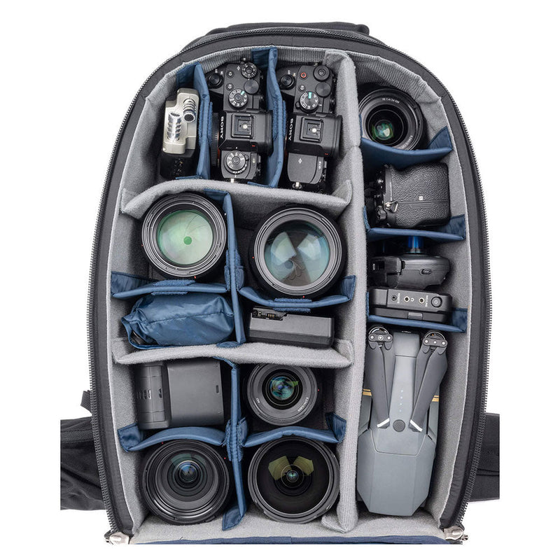 Top-down view of ThinkTank FirstLight 46L+ backpack showing organized camera gear and lenses in padded compartments
